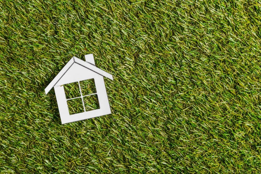Energy efficiency concept with paper house on grass